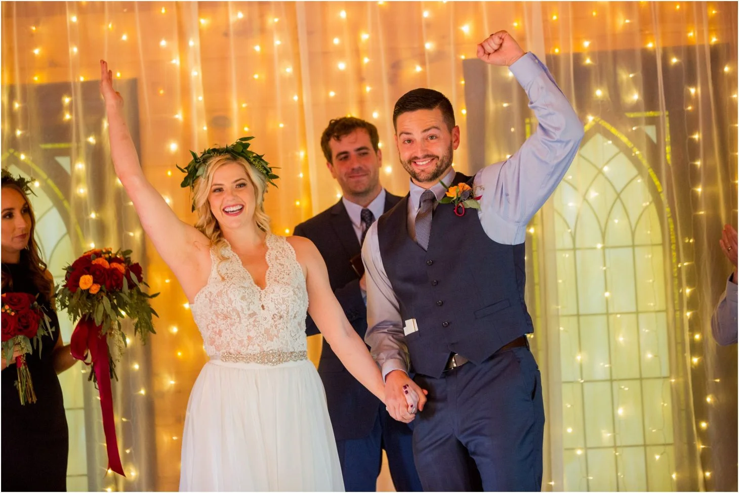 Indoor wedding ceremony space with fairy light backdrop and happy couple at Moose Hollow Lodge in Pigeon Forge