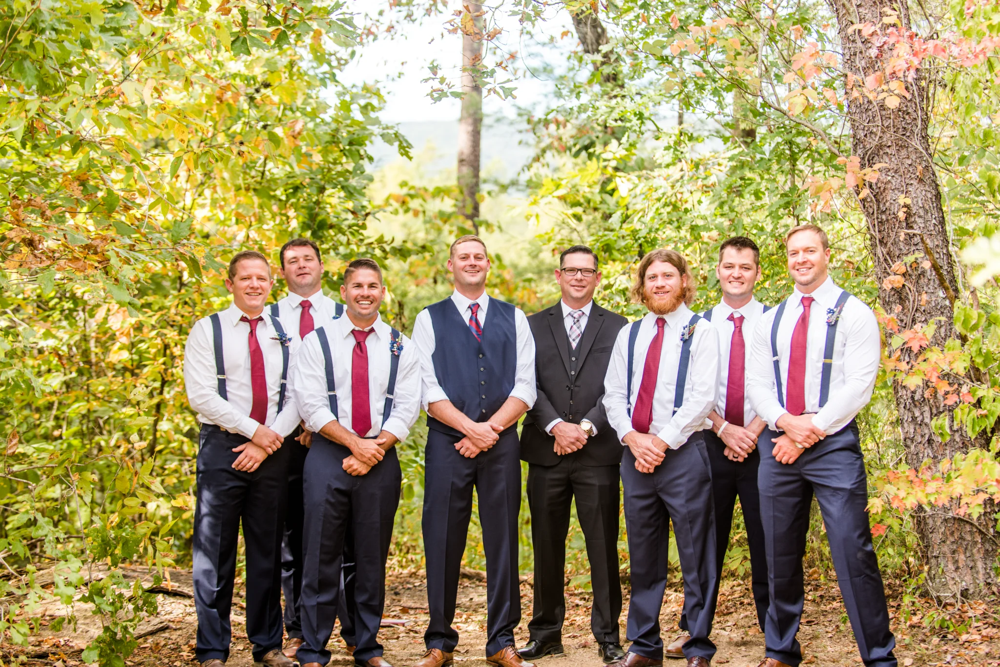 Groomsmen posing in a forest wedding setting near Smoky Mountains at Moose Hollow Lodge in Pigeon Forge