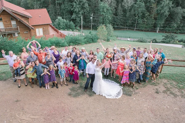 Wedding group on hillside with log cabin views at Moose Hollow Lodge in the Smoky Mountains near Dollywood