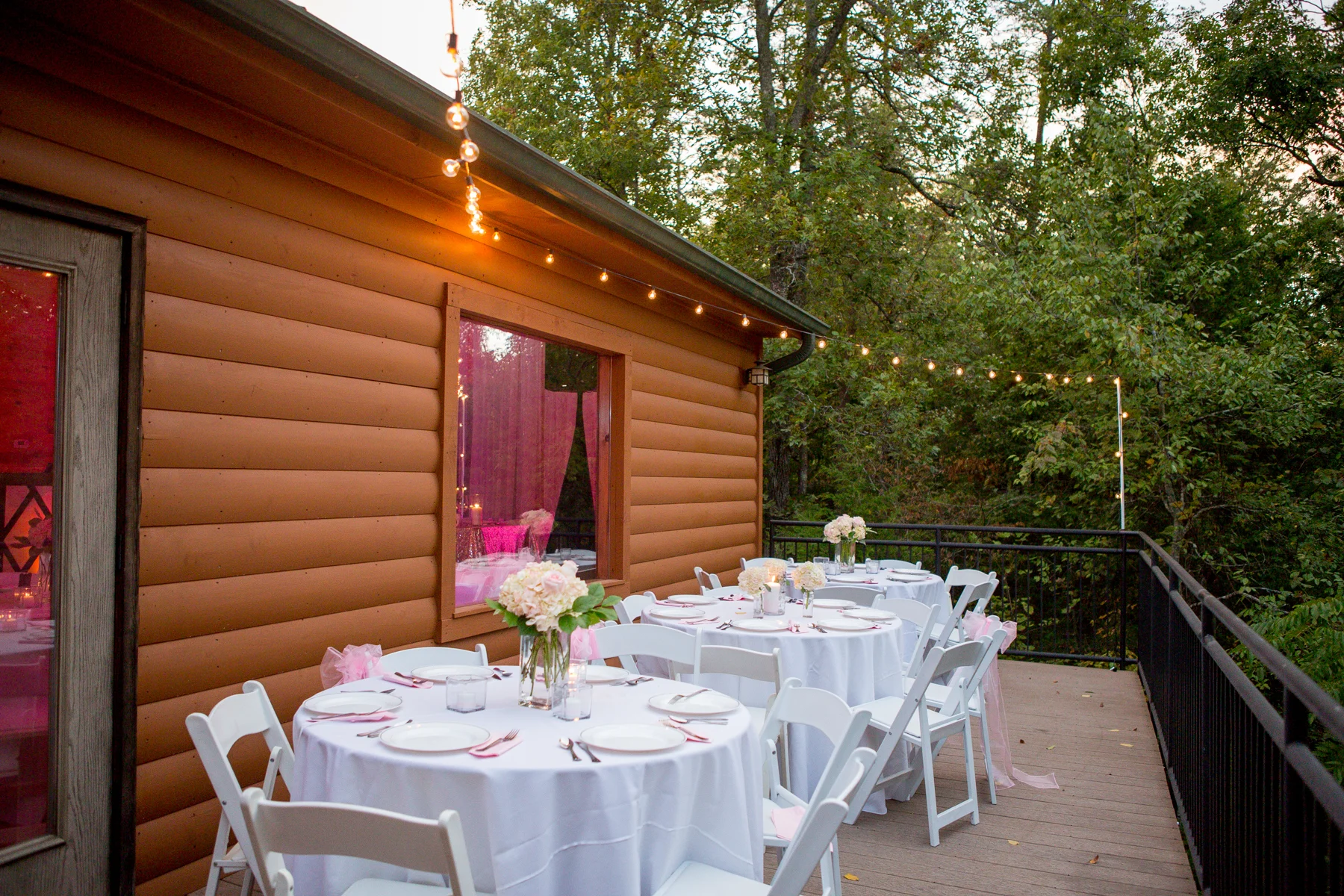 Outdoor wedding tables and string lights on a deck near the Smoky Mountains at Moose Hollow Lodge in Pigeon Forge