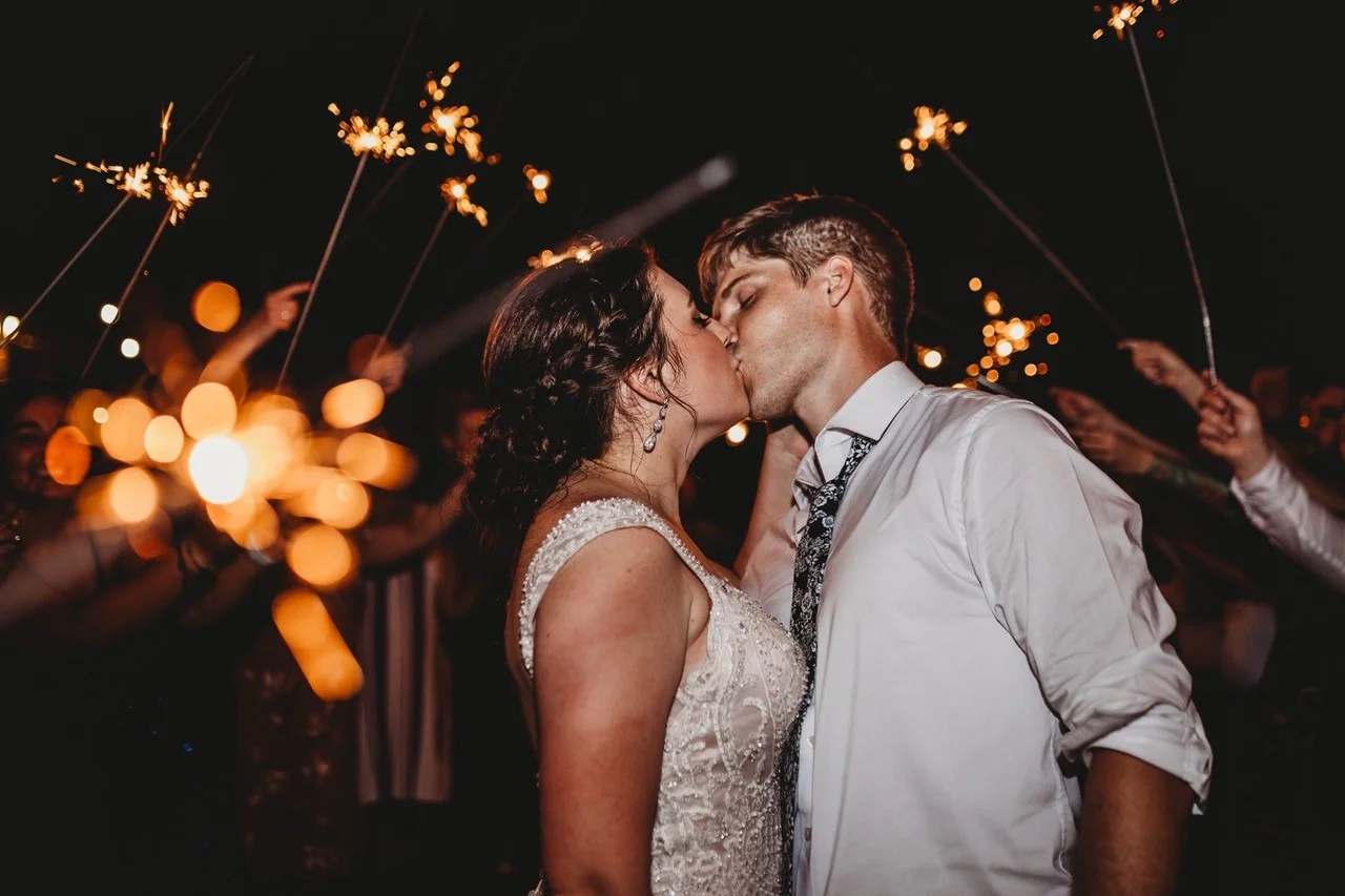 Newlyweds kissing during a sparkler send-off at Moose Hollow Lodge in Pigeon Forge near the Smoky Mountains