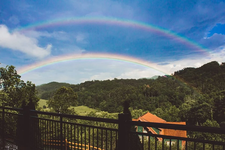 Vibrant double rainbow over Smoky Mountains forest views at Moose Hollow Lodge near Dollywood in Pigeon Forge