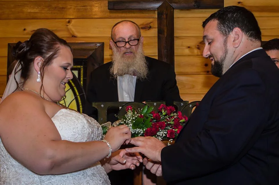 Bride and groom exchanging rings during a chapel ceremony at Moose Hollow Lodge in Pigeon Forge
