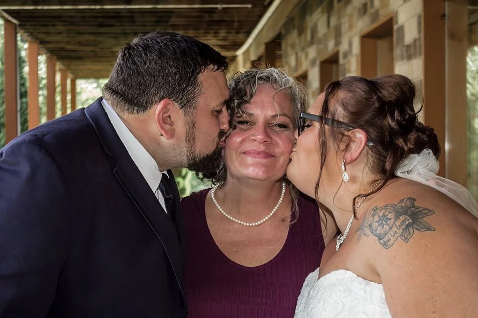 Wedding couple kissing family on a deck at Moose Hollow Lodge in Pigeon Forge near Dollywood and Smoky Mountains