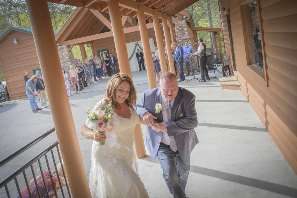 Newlyweds on covered porch at wedding venue Moose Hollow Lodge in Pigeon Forge near the Smoky Mountains
