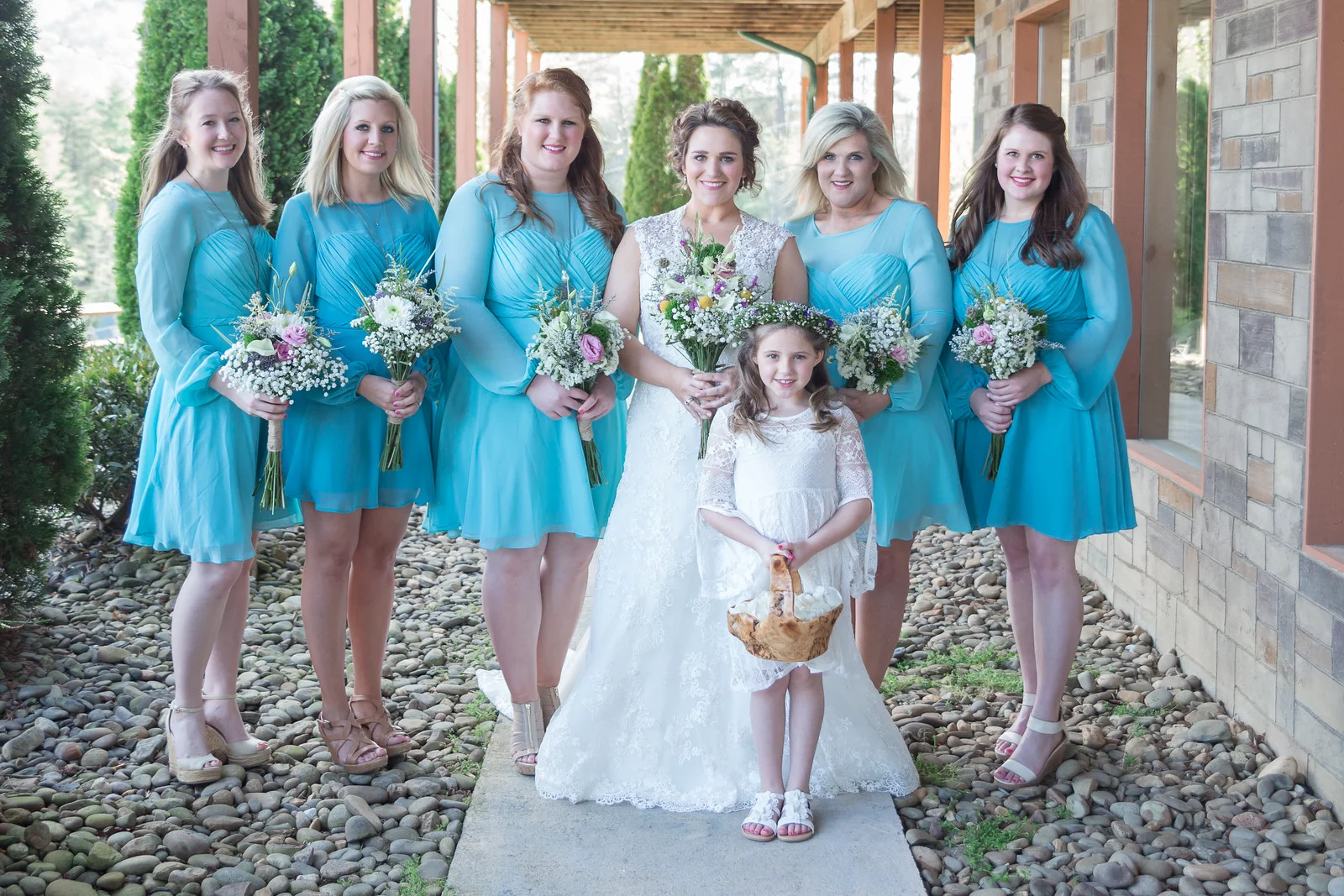 Wedding party posing outdoors on a stone patio at Moose Hollow Lodge in Pigeon Forge near the Smoky Mountains