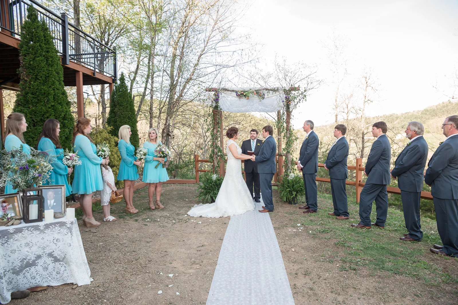 Outdoor wedding ceremony under floral arbor with forest views near Dollywood at Moose Hollow Lodge in Pigeon Forge