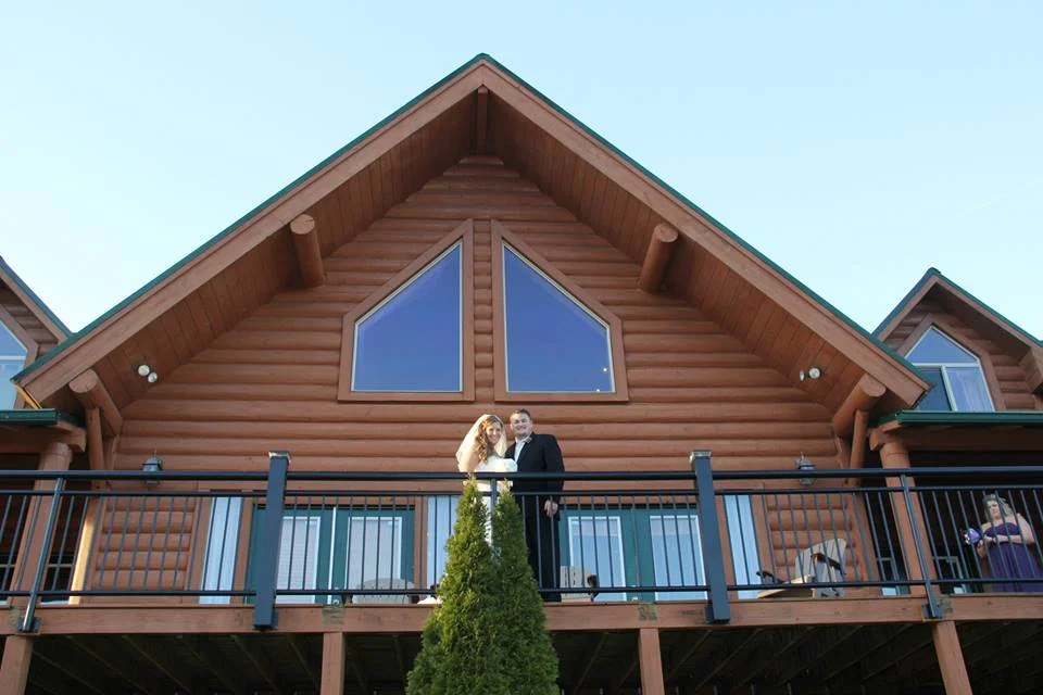 Newlyweds on a cabin balcony at Moose Hollow Lodge in Pigeon Forge near Dollywood and Smoky Mountains