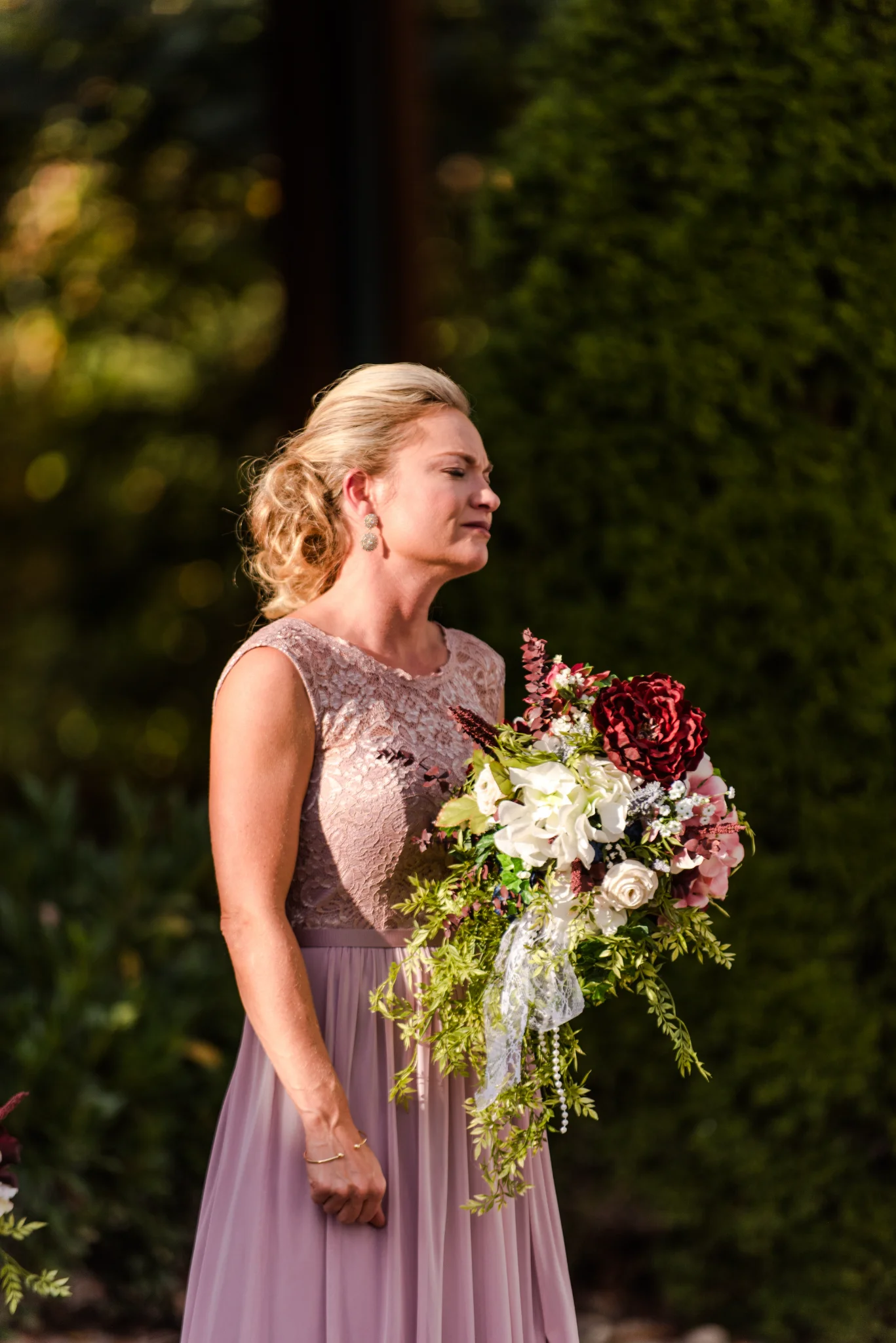 Woman with floral wedding bouquet outdoors near Smoky Mountains at Moose Hollow Lodge in Pigeon Forge
