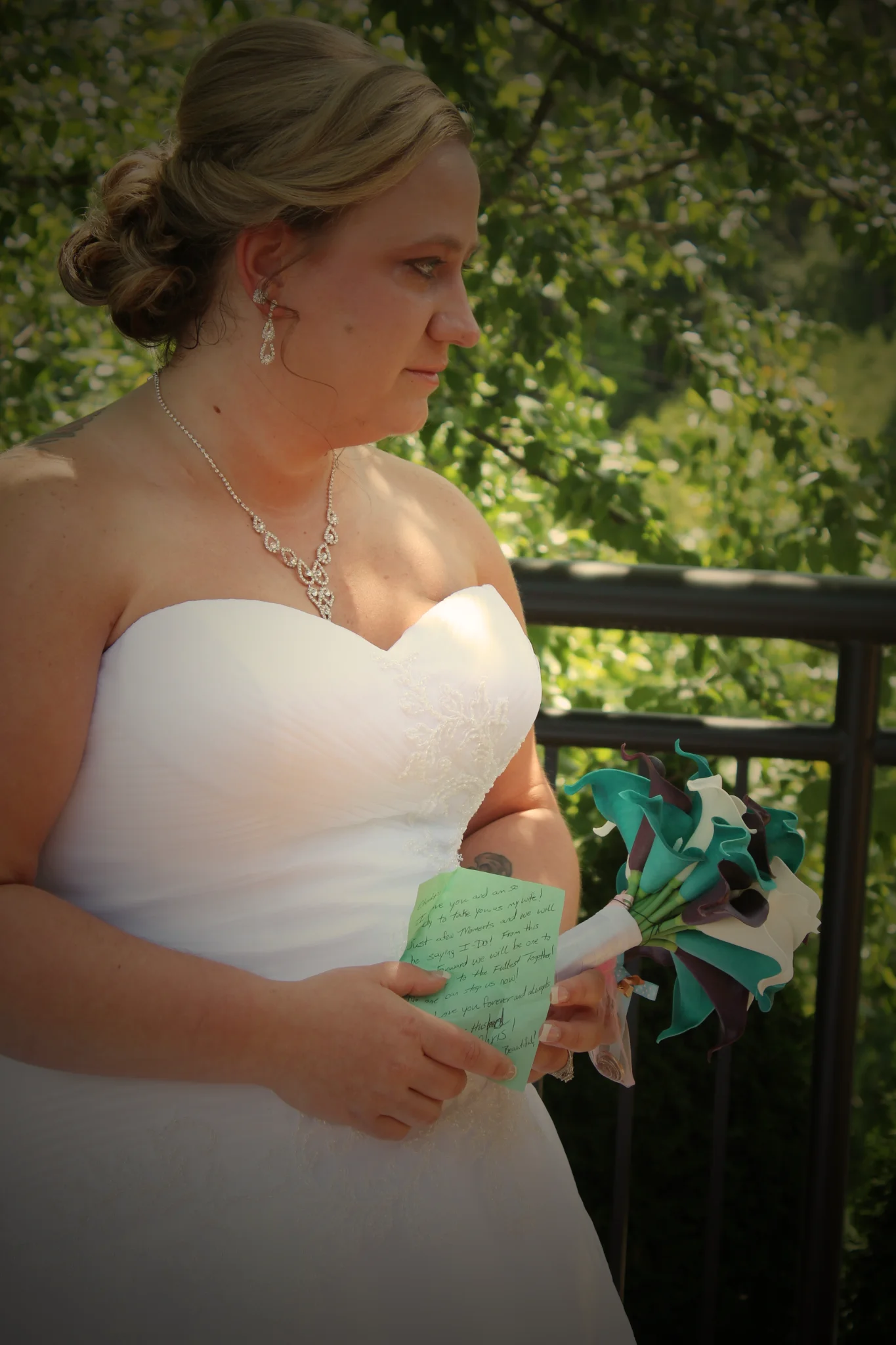 Bride with calla lily bouquet on outdoor deck in the Smoky Mountains at Moose Hollow Lodge in Pigeon Forge