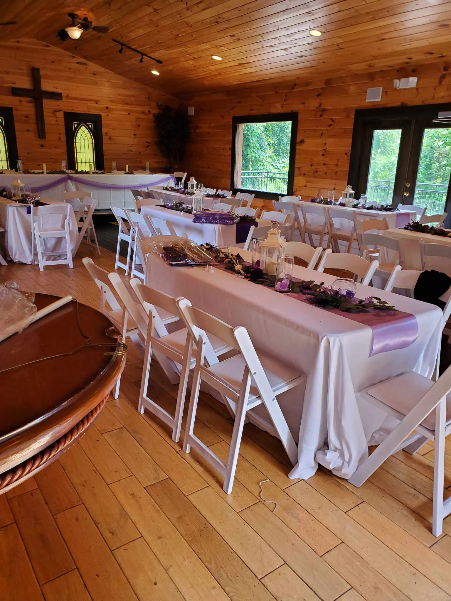 Rustic wedding reception hall with white linens and purple decor at Moose Hollow Lodge in Pigeon Forge