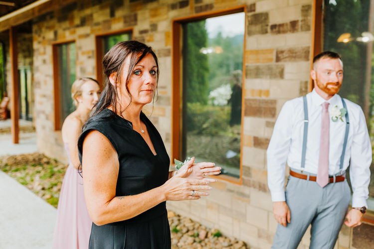 Woman in black dress with corsage, man in suspenders, woman in lavender dress outside Moose Hollow Lodge.